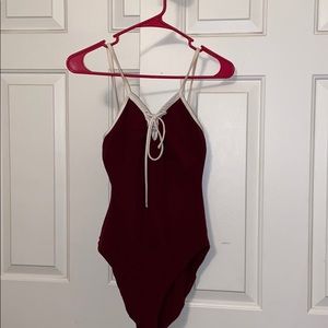 Burgandy lace up body suit.